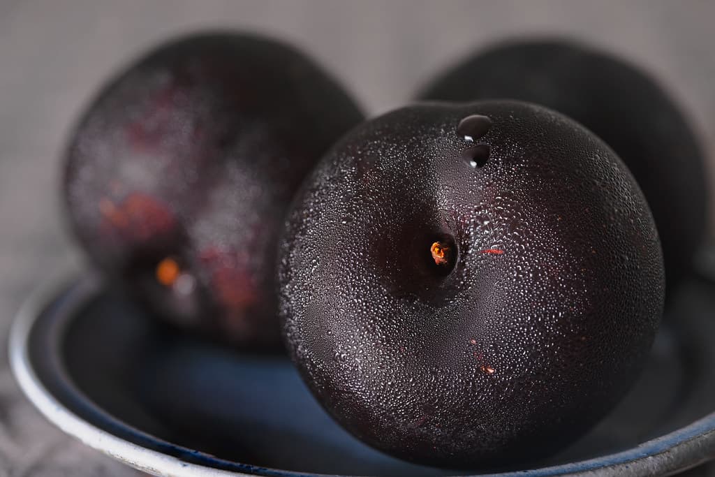 Organic plums in a natural kitchen setting